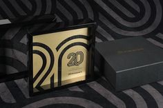 a black box with the number twenty two on it next to a gold and black gift box