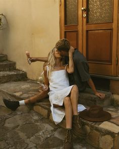 a man and woman sitting on steps next to each other