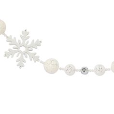 a white snowflake is hanging from a chain with balls and beads on it