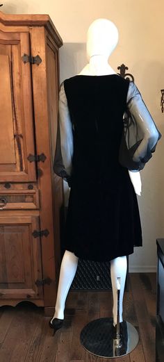 "This is a Darlong vintage 1960's 70\"s dress. It is a rich black rayon velvet with the white satin collar, sheer bib bodice and those gorgeous sheer poet sleeves. It is fitted through the bodice with a flared A line skirt. There is a full nylon zipper in back. Condition is good with some very pale soiling stains on collar. Hem has been let down. Tagged \"Joan Leslie by Kasper\" Measurements lying flat: Shoulders 14.5\", Bust 16.5\", Waist 14\", Hips 22\", Length 41\"" Black Vintage Dress For Fall, Vintage Fitted Dress With Sheer Sleeves, Vintage A-line Dress For Fall Evening, Vintage A-line Evening Dress For Fall, Fall Evening Vintage A-line Dress, Vintage Evening Dresses With Sheer Sleeves, Vintage Velvet Cocktail Dress, Black Long Sleeve Dresses For Vintage Events, Joan Leslie