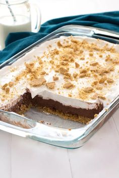 a cake in a pan on a table next to a glass container with some milk