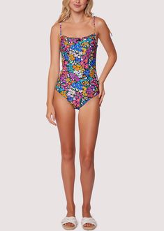 ELIGIBLE FOR RETURNS OR EXCHANGES Start your vacation with a beach view in the Renoir's Terrace Ruffle One-Piece Swimsuit! This floral inspired pattern is featured in an array of spring colors to bring charisma as you dip your toes into the sand. The bust features a a small ruffle trim and sweet bow for a feminine touch. Adjustable strap tie details are found at the shoulder for better support! Style # WMKC09047 Imported 80% Nylon, 20% Spandex Model is 5 ft 9 inches; Bust: 32", Waist: 23.5", Hip Fitted Floral Print One Piece For Beach Party, Fitted Floral Print One-piece For Beach Party, Fitted One Piece With Floral Print For Beach Party, Tropical One-piece Swimwear For Spring, Beachy Printed Swimwear For Summer Parties, Floral Print Swimwear For Beach Party During Resort Season, Floral Print One-piece Swimwear For Vacation, Printed Swimwear For Summer Parties And Vacation, Beachy One-piece Floral Print Swimwear