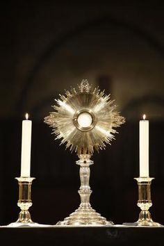 three candles are lit in the middle of a table