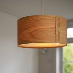 a wooden light fixture hanging from a ceiling