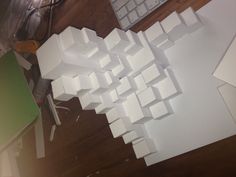 a pile of white cubes sitting on top of a wooden floor next to a keyboard