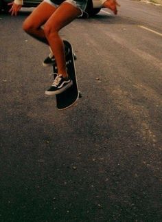 a person jumping in the air on a skateboard with their feet off the ground