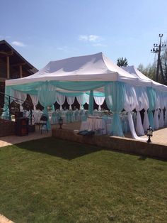 a large tent set up with tables and chairs