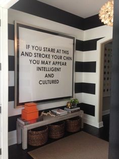 a black and white striped room with a quote on the wall