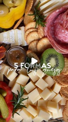 an assortment of cheeses, crackers and meats arranged on a platter