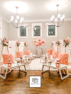 a room with chairs and pink decorations on the walls, along with chandeliers