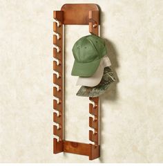 a hat rack with hats hanging from it's sides and a baseball cap on top