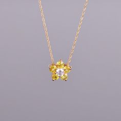 A dainty and beautiful flower pendant with .20 carats of yellow sapphires and a .11 carat diamond center. All set in 14k yellow gold. Dimensions are 9.6mm x 9.4mm Yellow Flower Shaped Jewelry For Anniversary, Yellow Flower-shaped Jewelry For Anniversary, Elegant Yellow Flower Pendant Necklace, Yellow Flower Jewelry For Anniversary, Dainty Yellow Flower Shaped Jewelry, Yellow Flower Pendant Jewelry For Wedding, Elegant Yellow Jewelry With Flower Charm, Yellow Flower Pendant Necklace For Weddings, Dainty Yellow Flower Pendant Jewelry