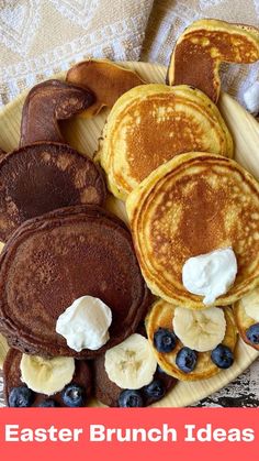 pancakes with butter and blueberries are on a plate, next to some other breakfast foods