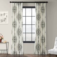 the curtains in this room are decorated with black and white flowers