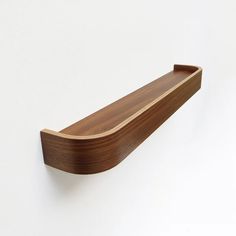 a wooden shelf mounted on the wall