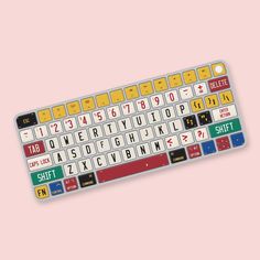 a computer keyboard with different colored keys on it's back end and bottom part