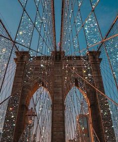 the brooklyn bridge is lit up with christmas lights