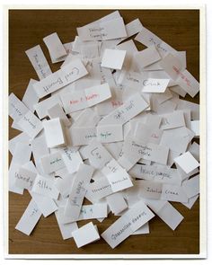 many pieces of paper with writing on them are piled together in a pile and placed next to each other