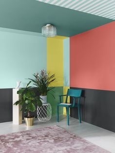 a colorful room with a chair and potted plant