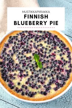 a blueberry pie in a white bowl with the title overlay reads finnish blueberry pie