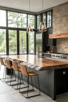 a large kitchen with an island counter and bar stools in front of the window