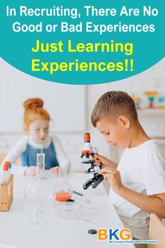 two children are sitting at a table with microscopes and beakles in front of them