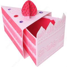 an open pink box with a strawberry on top and polka dot trimmings around the bottom