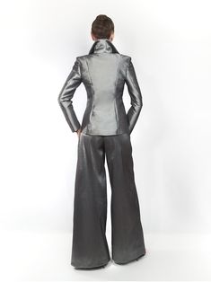 Our EXCLUSIVE limited edition. Dark silver semi stretch taffeta ladies pantsuit. Made exclusively to order in house. Introducing my latest obsession: a made-to-measure, dark-silver pantsuit that’s perfect for summer days at the office! ☀️ This sexy and feminine silhouette features strong shoulders and a stand-up collar, making a bold statement while keeping me comfortable all day long. 💃 Plus, it’s wrinkle-free, easy to care for, and incredibly flattering! 🌟 Say goodbye to wardrobe dilemmas and hello to effortless style with this must-have piece. CARE: Dry clean only TURNOUROUND TIME: 14 - 19 business days processing + shipping via USPS. You can choose express USPS express shipping as well. Contact us if you need to hurry. +++++++++++++++++++++++ Size Guide https://mologokocouture.com/pa Elegant Silver Party Pants, Elegant Silver Pants For Evening, Fitted Satin Pantsuit For Workwear, Elegant Fitted Silver Bottoms, Silver Elegant Evening Bottoms, Metallic Fitted Pants For Formal Occasions, Silver Fitted Bottoms For Formal Occasions, Elegant Fitted Silver Pants, Elegant Fitted Metallic Bottoms