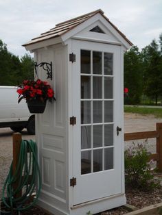 a potted plant sitting on top of a white shed