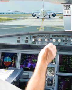 a man is sitting in the cockpit of an airplane and looking at the view through the pilot's window