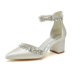 a pair of white high heeled shoes with crystal embellishments on the ankle