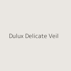 the words dulux delicate veil are shown in black on a light gray background