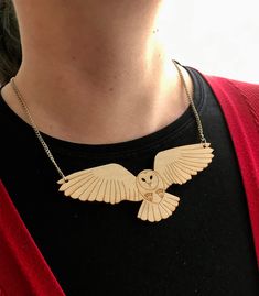 a person wearing a necklace with an owl on it