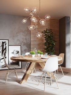 a dining room table with white chairs and a light fixture hanging from it's ceiling