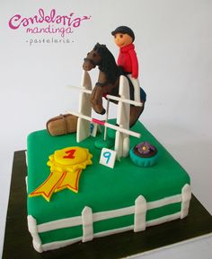 a birthday cake with a horse and jockey on it's back, sitting on top of a green field