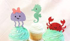 three cupcakes with sea creatures on them