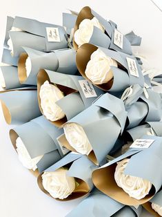 a pile of blue and white paper flowers on top of each other