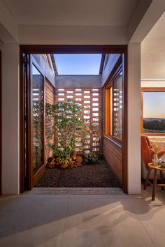 the inside of a house with an open door leading to a patio and dining area