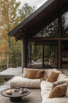 a large couch sitting on top of a wooden deck next to a table and chairs