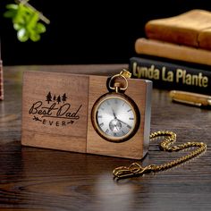 Personalized Engraved Wooden Pocket Watch with Stand - Father's Day Gift, Anniversary Gift for Him, Groomsmen Watch Description: Looking for a gift that will make a statement? Look no further than this incredible custom pocket watch! With its sleek design and stunning snakewood watch stand, it's sure to impress. Personalization: But that's not all - you can also personalize this pocket watch with your own message on the watch stand and/or back side of the watch. Make it a truly special gift by adding a heartfelt engraving. Perfect Gift for Various Occasions: This pocket watch is the perfect anniversary gift for him, a thoughtful Father's Day present, or a memorable token for milestones like a 21st birthday. It's also an ideal choice for groomsmen's gifts. No matter the occasion, this perso Engraved Pocket Watch, Timeless Watch Accessories With Date Display As Gift, Timeless Gift Watches With Date Display, Timeless Watches With Date Display As A Gift, Timeless Watch With Date Display As Gift, Brown Chronometer Watch As Gift, Personalized Pocket Watch As A Gift, Classic Engraved Pocket Watch For Anniversary, Brown Chronometer Watch For Gift