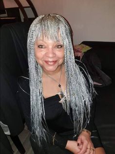 This mini box braids wig with bangs (aka baby face) is your go-to wig if you want to look classy. It is light weight and comfortable to wear, with an elastic band to secure it to the head. Please note that this style does not have baby hairs Color shown is a mix of gray and black, with more gray. Color can be customized. Back length is 22 inches but can also be customized. Processing time is 2 to 3 weeks Grey Hair Braids Black Women, Bangs With Braids, Braided Hairstyles With Bangs, Grey Box Braids, Grey Hair Braids, Box Braids Wig, Grey Hair Inspiration, Kanekalon Hairstyles, Beautiful Gray Hair