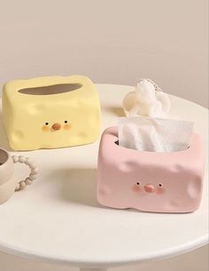 two little pig tissue dispensers on a table