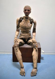 a statue of a man sitting on top of a wooden box