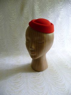 "Molded faux felt pillbox style fascinator hat base in pretty lipstick red that measures 6.5\" x 5.5\" - and has a contoured shape to fit on the head. Low side is approximately .75\" and the higher side is approximately 1.5\". Just attach an alligator clip inside or an elastic to make this a breeze to wear. A cute little base ready for your next DIY millinery project. Easy to decorate with many of the flowers and leaves available in my shop! (PLEASE NOTE this is a FASCINATOR SIZE HAT BASE not a Formal Winter Red Felt Hat, Classic Red Felt Hat For Formal Occasions, Red Adjustable Felt Hat For Formal Occasions, Adjustable Red Felt Hat For Formal Occasions, Classic Red Formal Felt Hat, Vintage Red Felt Hat With Short Brim, Fitted Red Brimmed Top Hat, Red Felt Hat With Curved Brim For Formal Occasions, Red Brimmed Felt Hat For Formal Occasions