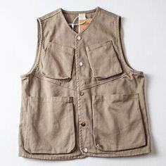 Spring Utility Vest With Pockets, Sleeveless Utility Outerwear With Pockets, Cotton Vest With Pockets For Fall, Khaki Winter Vest With Pockets, Fall Cotton Vest With Pockets, Spring Sleeveless Vest With Patch Pockets, Sleeveless Military Outerwear In Khaki, Outdoor Vest With Cargo Pockets For Fall, Utility Vest With Patch Pockets For Spring