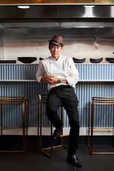 a man wearing a hat sitting on a chair