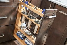 an open pull out cabinet in a kitchen