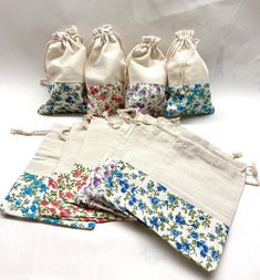 six small draws are lined up in different colors and patterns, each with flowers on them