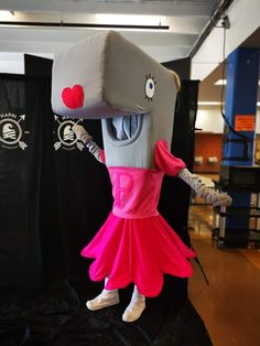 a person in a costume standing on a stage