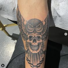 an owl and skull tattoo on the left leg is shown in black and grey colors